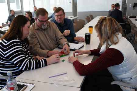 Corporate staff at Alvine Engineering work on team building skills with Legos.