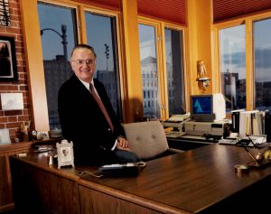 Raymond G. Alvine sitting at his desk