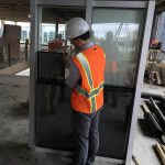 Brandon Rich comparing windows at the 1201 Cass construction site