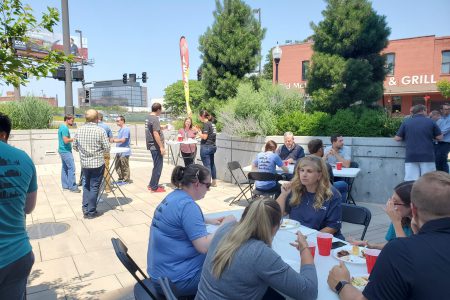 Alvine Engineering staff eat lunch to celebrate the firm's 60th anniversary