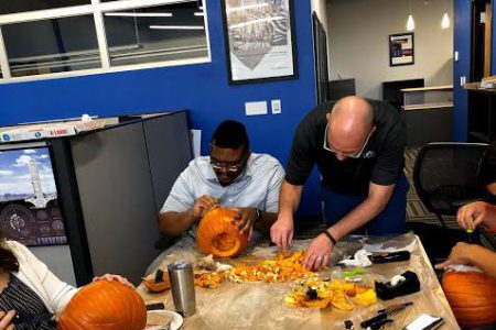 OKC Alvine staff carve pumpkins.